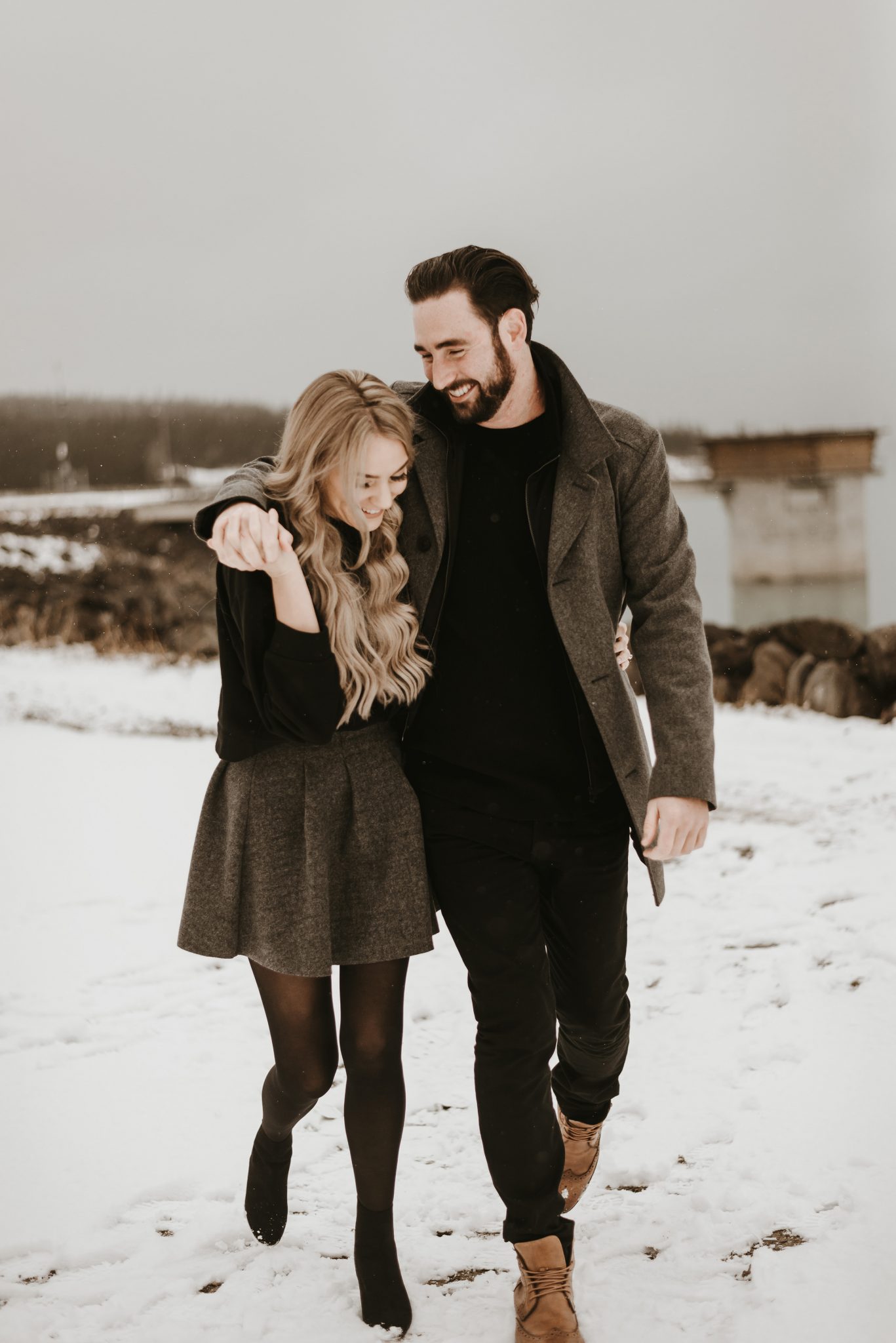 Winter engagement session, while couple walks through snow, hand in hand, engagement session inspiration. 