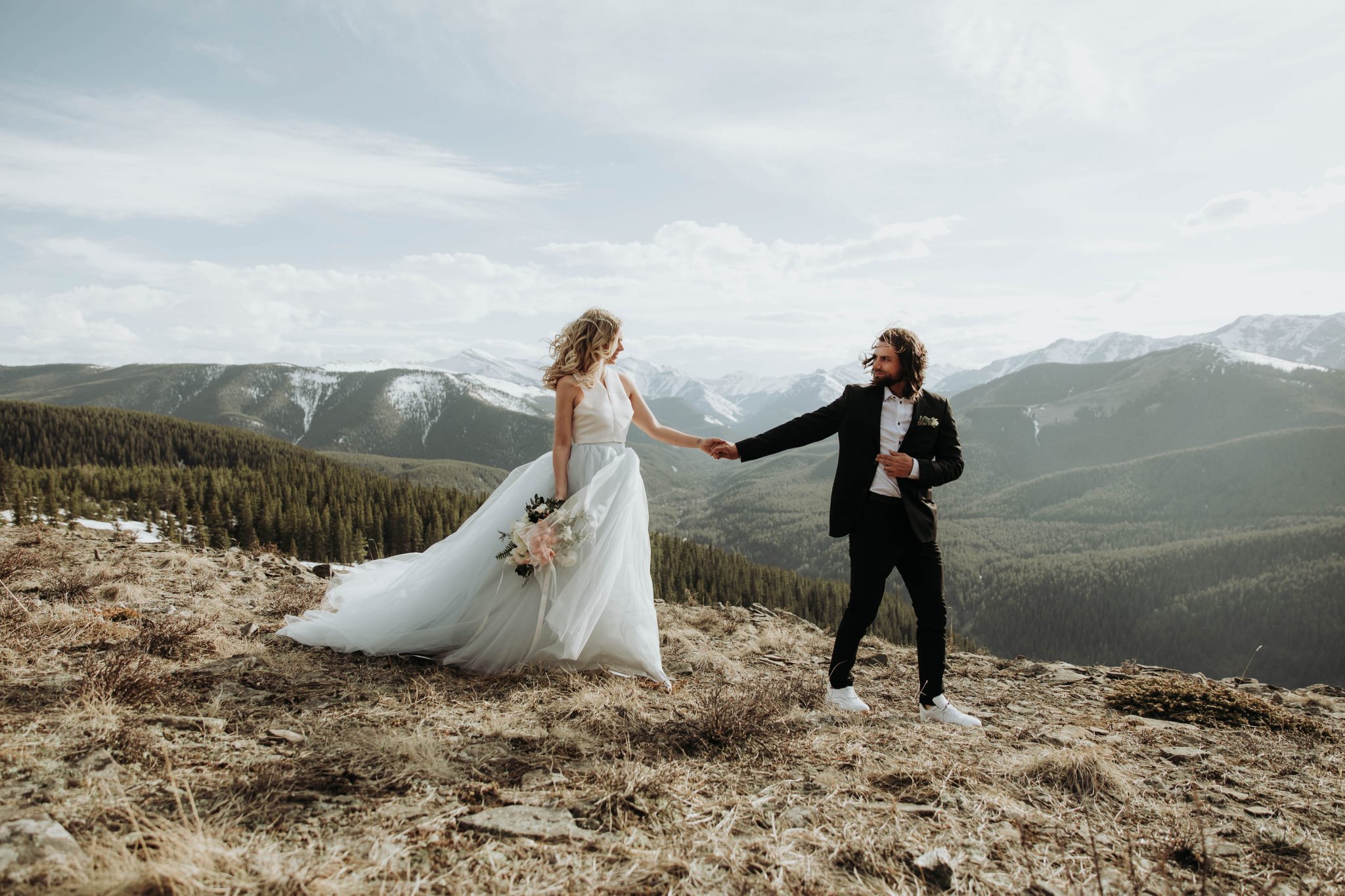 Groom with Sneakers Mountainous Adventure Session featuring Contemporary Attire & Alberta Views Featured on Bronte Bridë