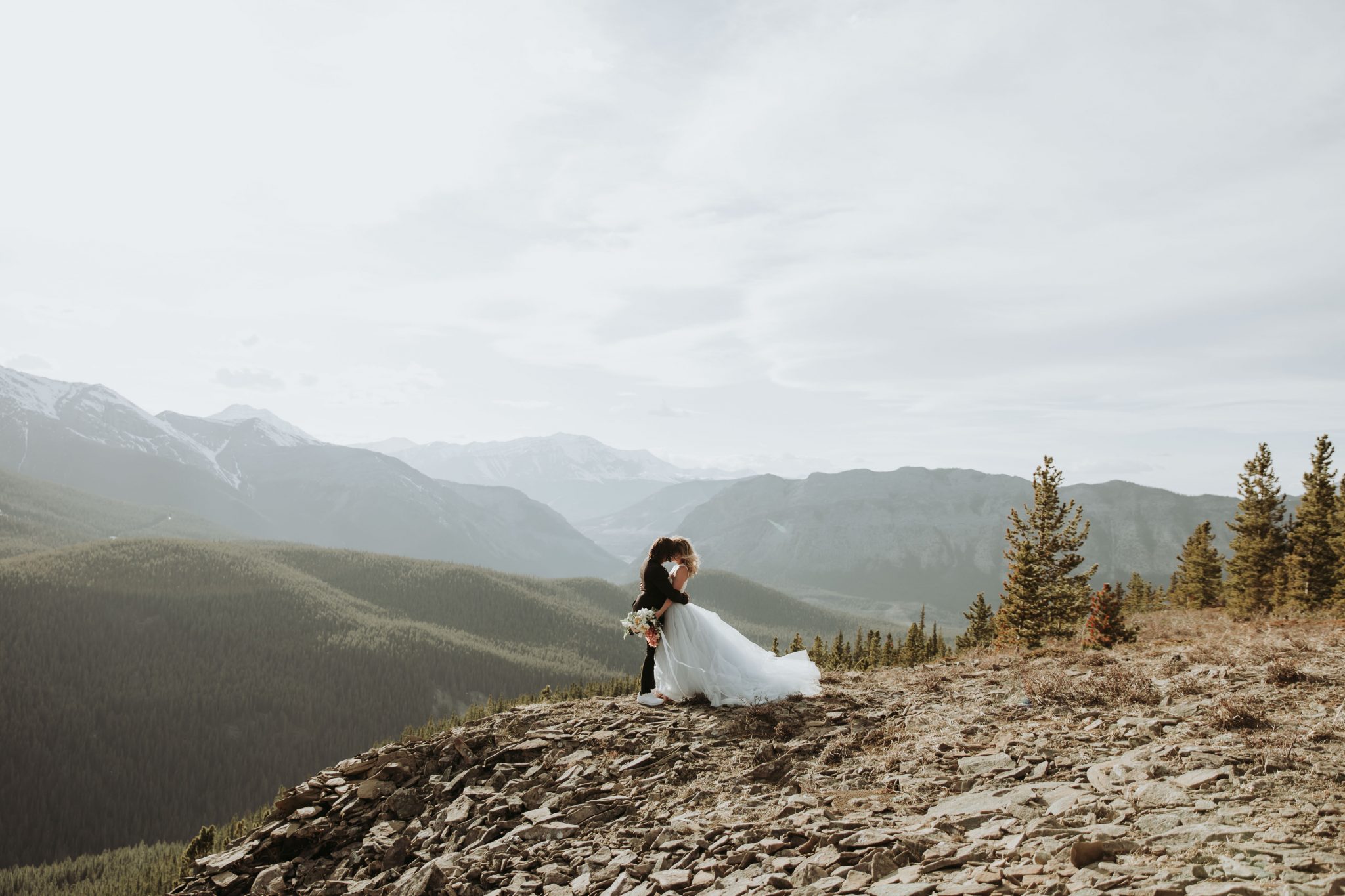 Flowing Wedding Dress Mountainous Adventure Session featuring Contemporary Attire & Alberta Views Featured on Bronte Bridë