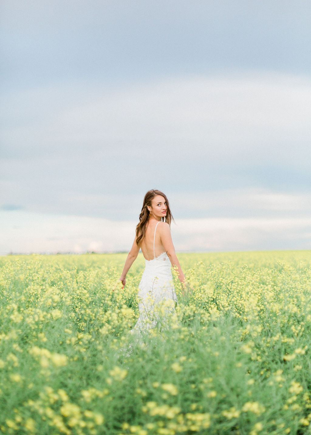 Canola field bridal portraits - backless dress, wildflower wedding