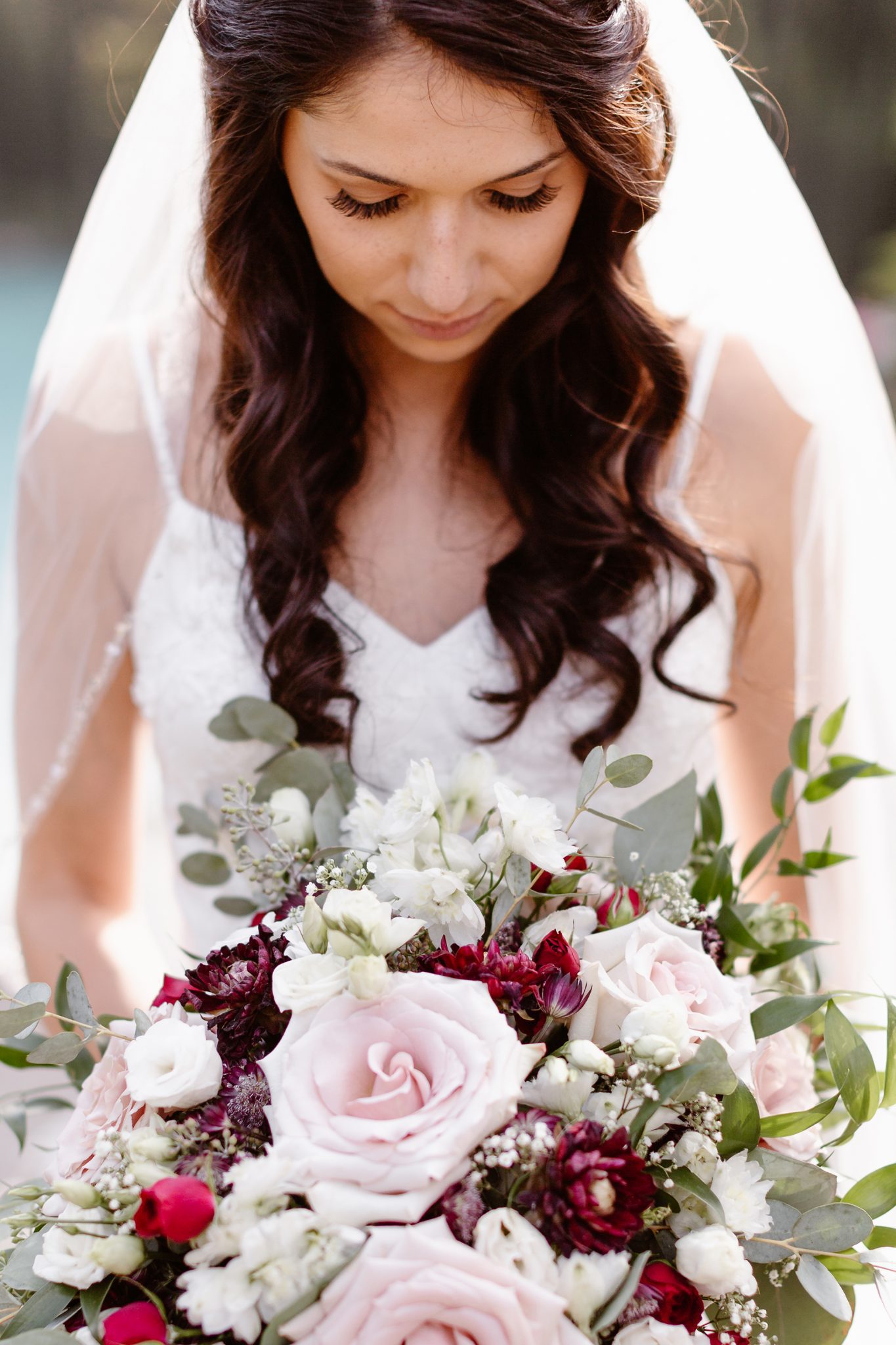 This Couple Ended up Loving Their Downsized Wedding at Fairmont Lake Louise - burgundy flowers, bridal boouquet