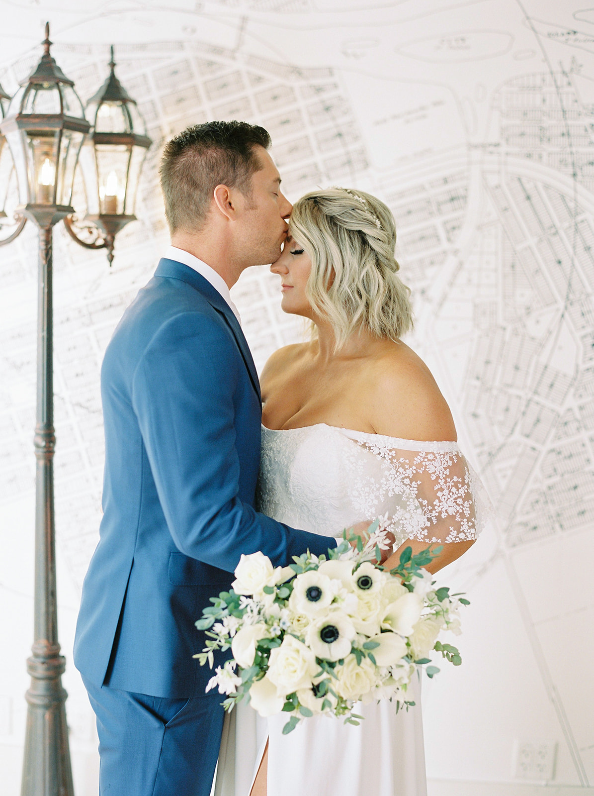 Groom in a sky blue suit, Parisian wedding inspiration, white bouquet