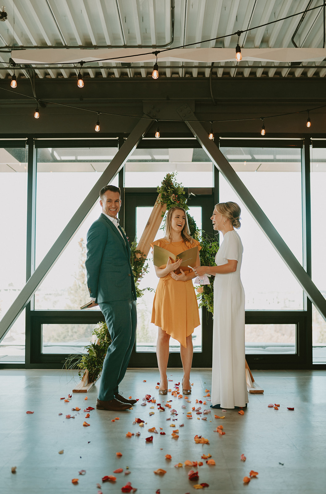 This Minimalist Micro-Wedding features a DIY Bouquet Made by the Bride Herself - indoor ceremony, triangle arch, modern wedding