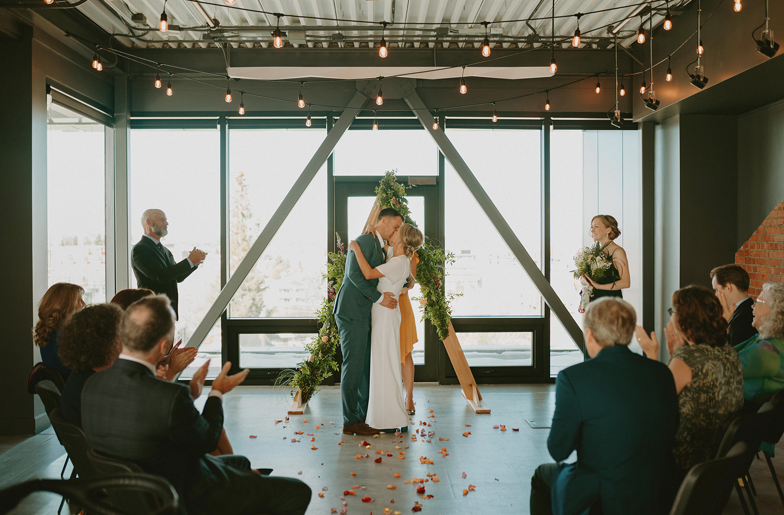This Minimalist Micro-Wedding features a DIY Bouquet Made by the Bride Herself - first kiss, indoor wedding ceremony