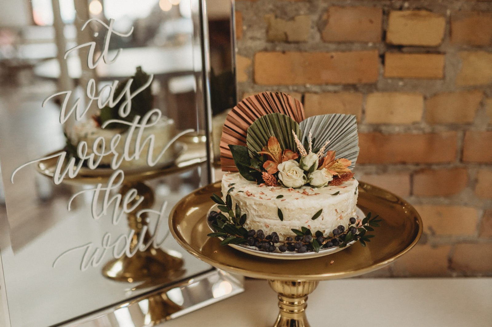Modern boho one tier white wedding cake with sage and orange details
