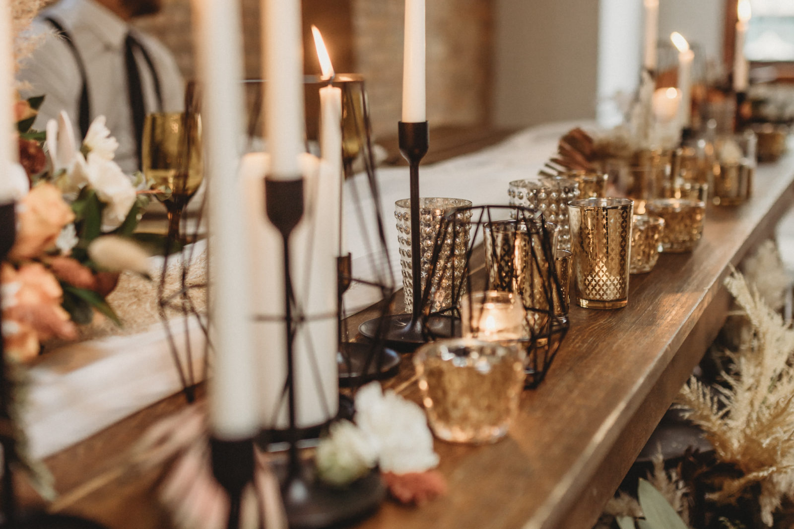 Gold candle holders on a styled sweetheart wedding reception table
