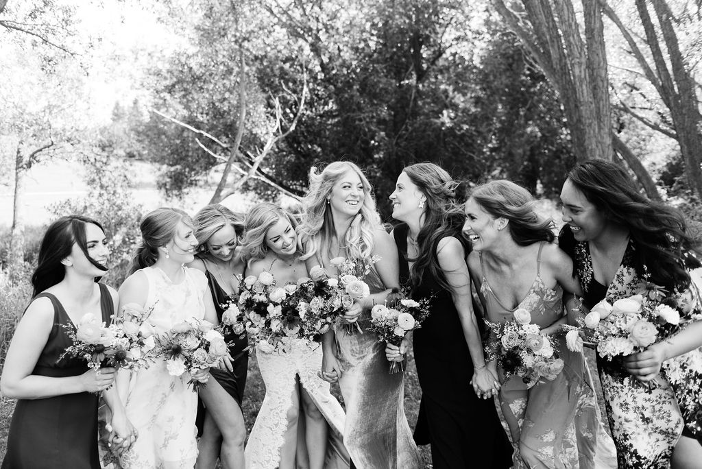 Black and white portrait of bridesmaids in mismatched gowns 