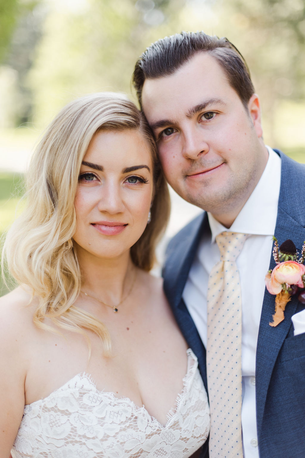 A portrait of a Calgary bride and groom with their heads close together on their wedding day