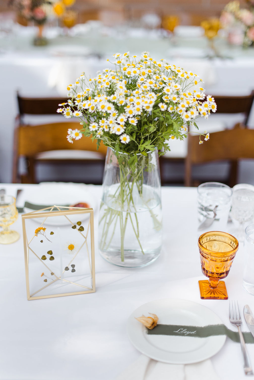Miniature daisies and whimsical wedding flowers photographed for a whimsical flower wedding and amber glass goblets