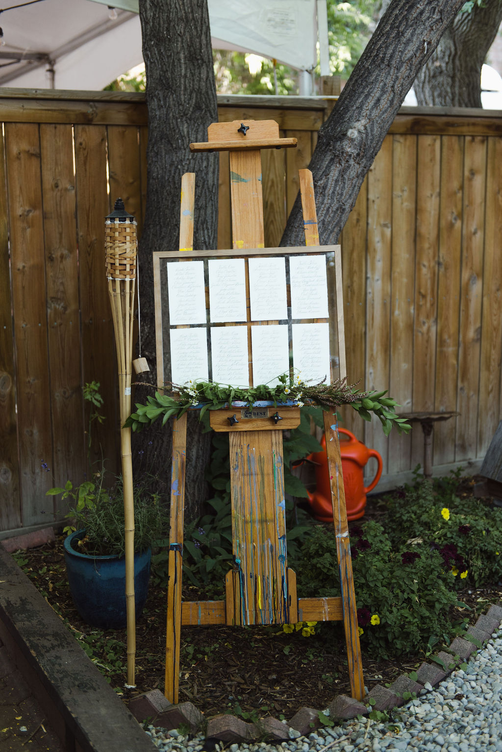 Modern seating chart display photographed next to a tiki torch
