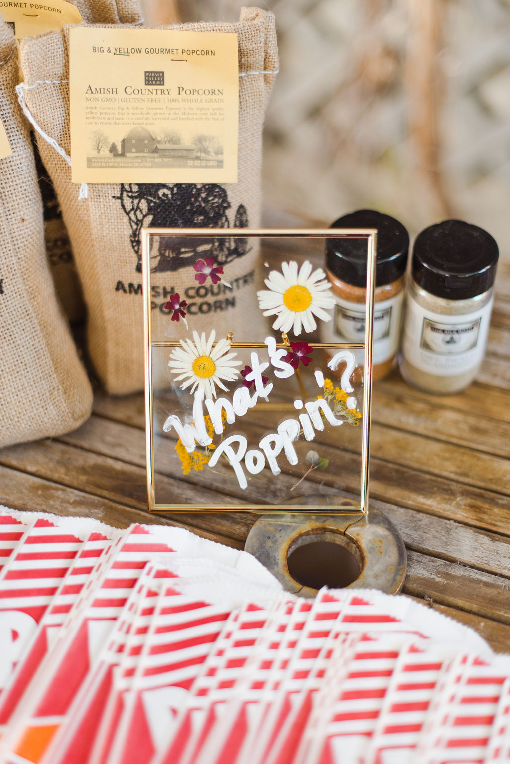 A wedding sign featuring popcorn with wildflower designs