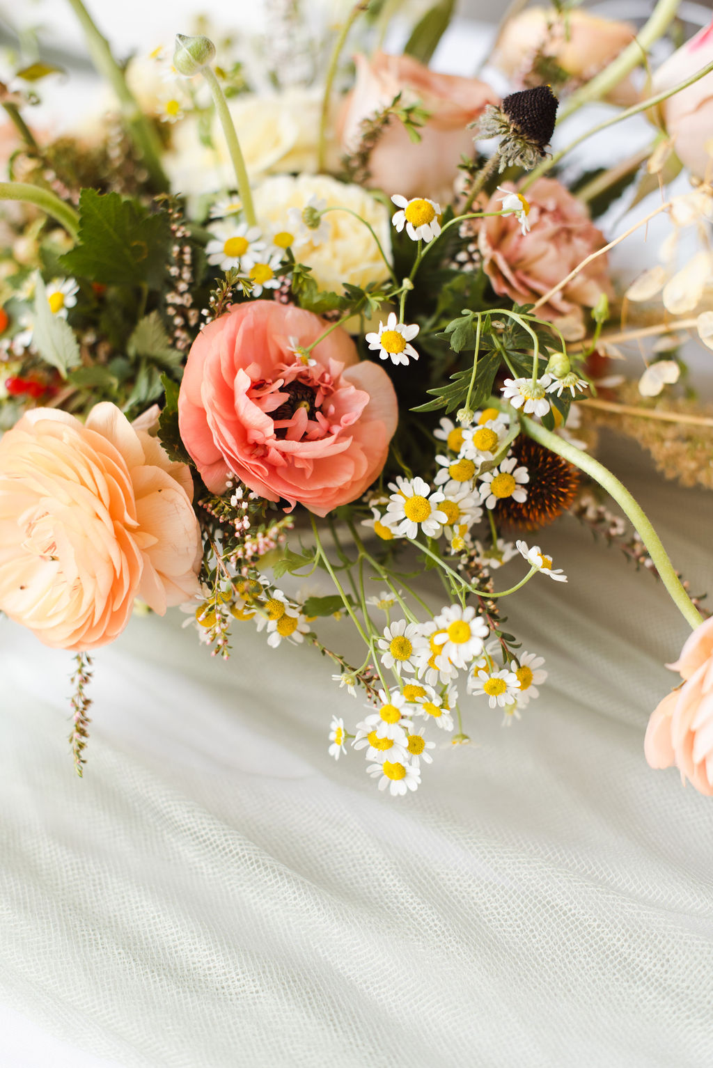Whimsical wedding flowers of blush tones styled by Faint Floral