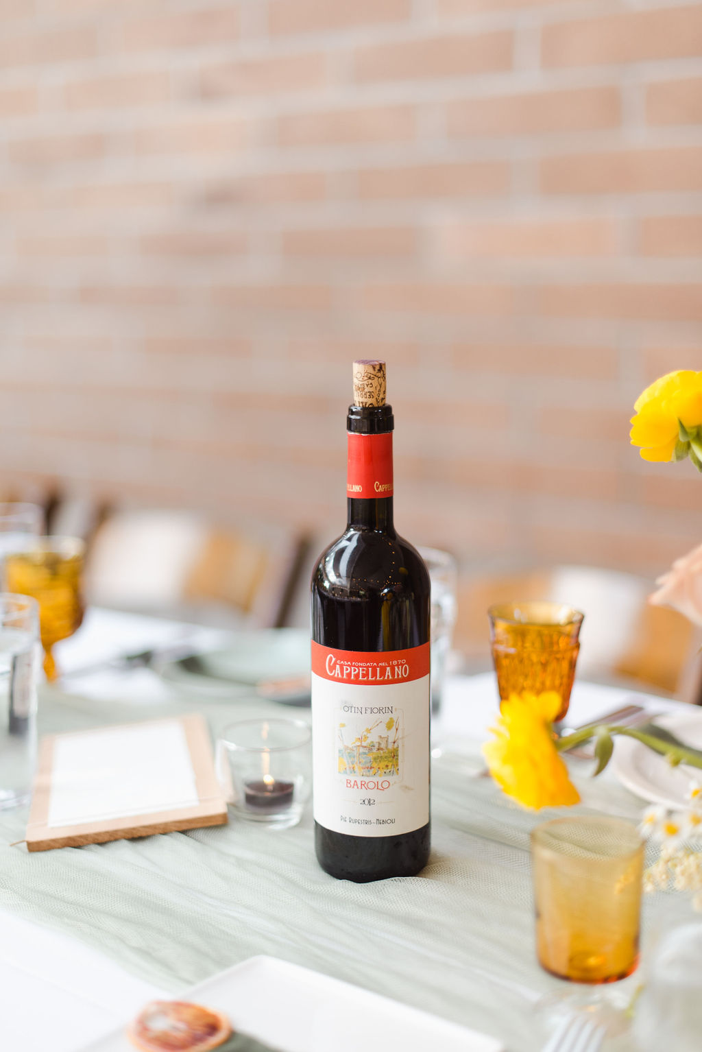 An Italian inspired wedding tablescape featuring red wine and amber glasses