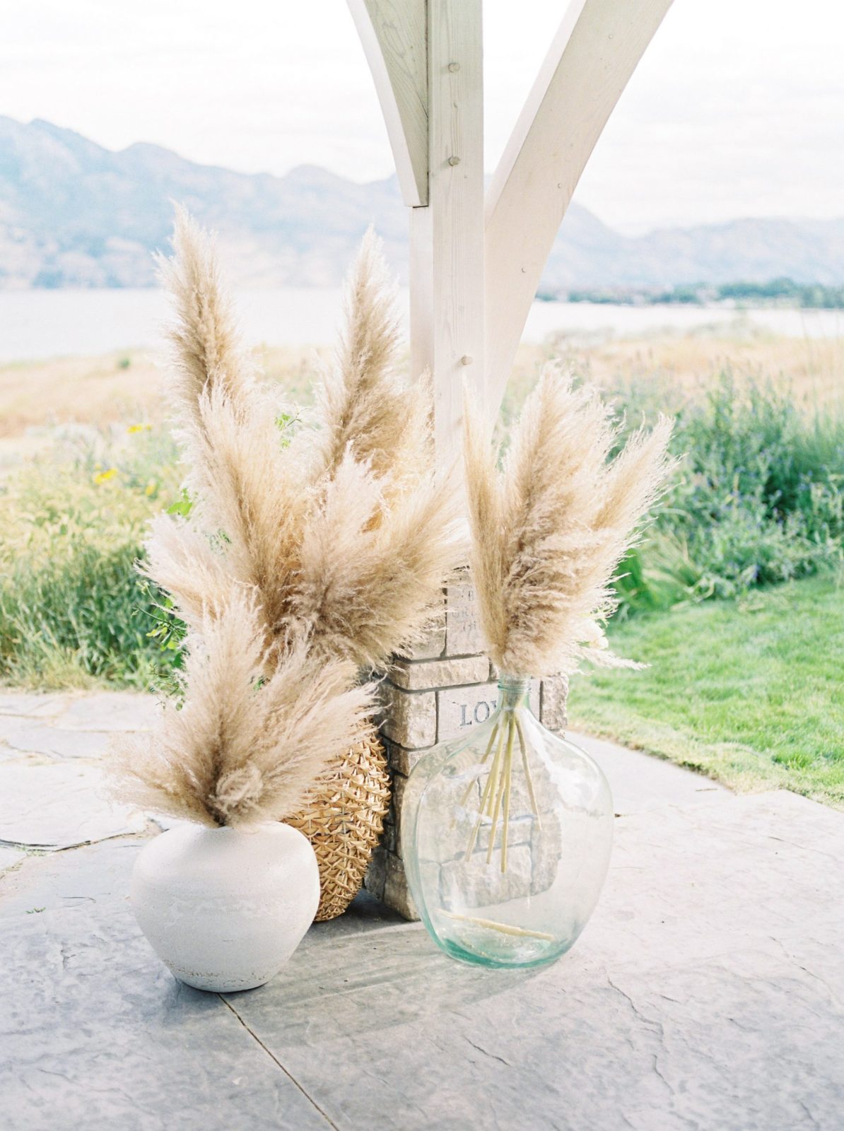 Pampas grass in clay and glass vases for a modern Okanagan ceremony