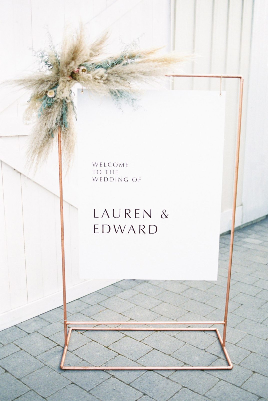 Modern wedding sign in white and copper welcoming guests to an Okanagan wedding ceremony