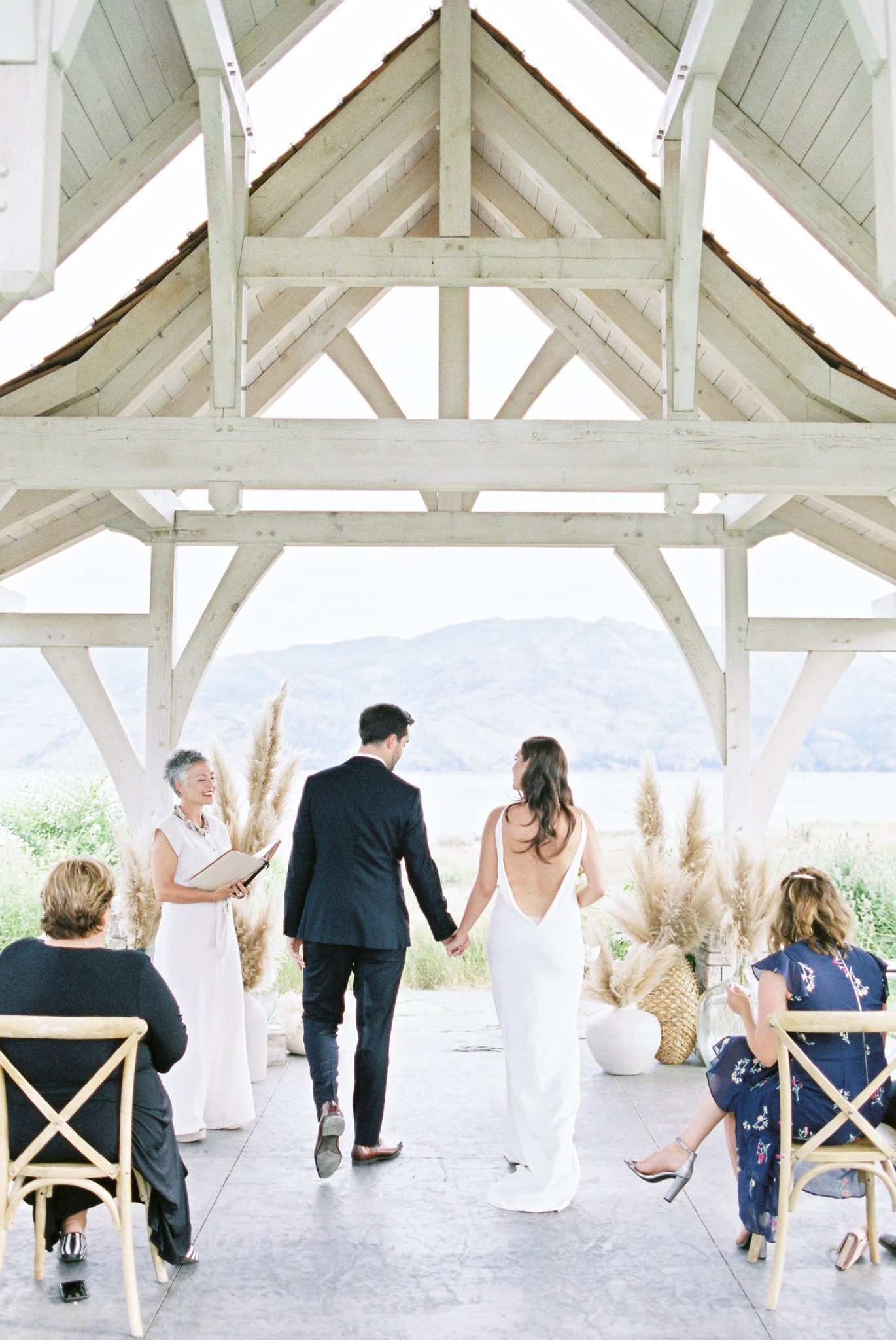 Bride and groom walk into the chapel inspired gazebo for their modern Okanagan ceremony in British Columbia