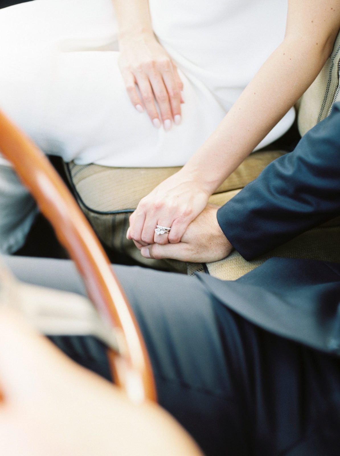 Bride and groom seated in a truck interior holding hands