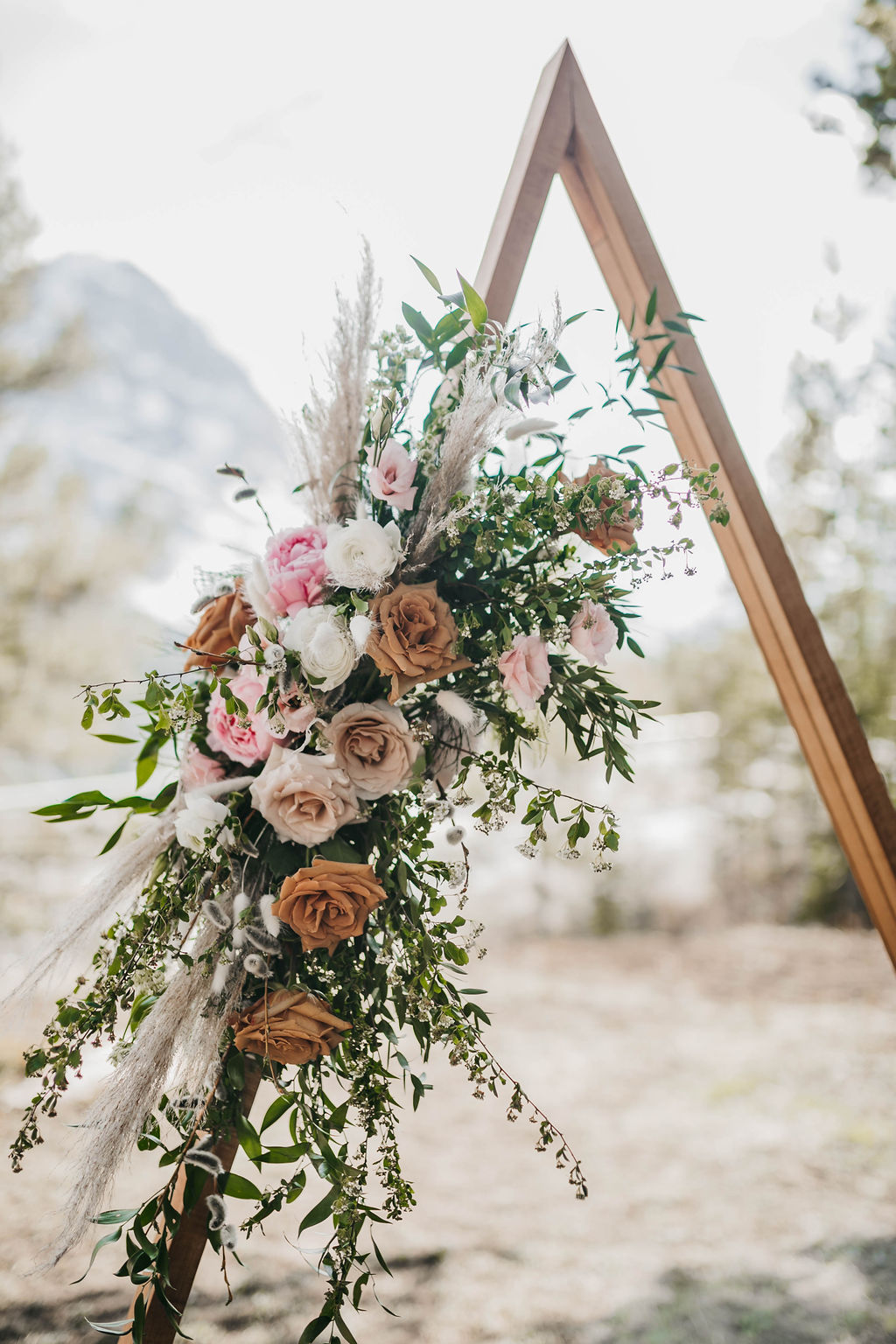 Toffee, caramel and blush roses on a triangle flower arch