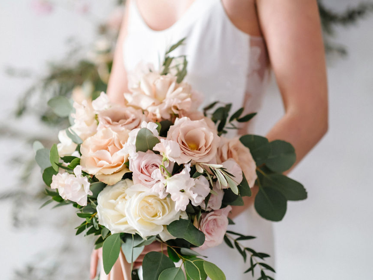 Blush bridal bouquet featuring quicksand roses, parvifolia eucalyptus and white snap peas