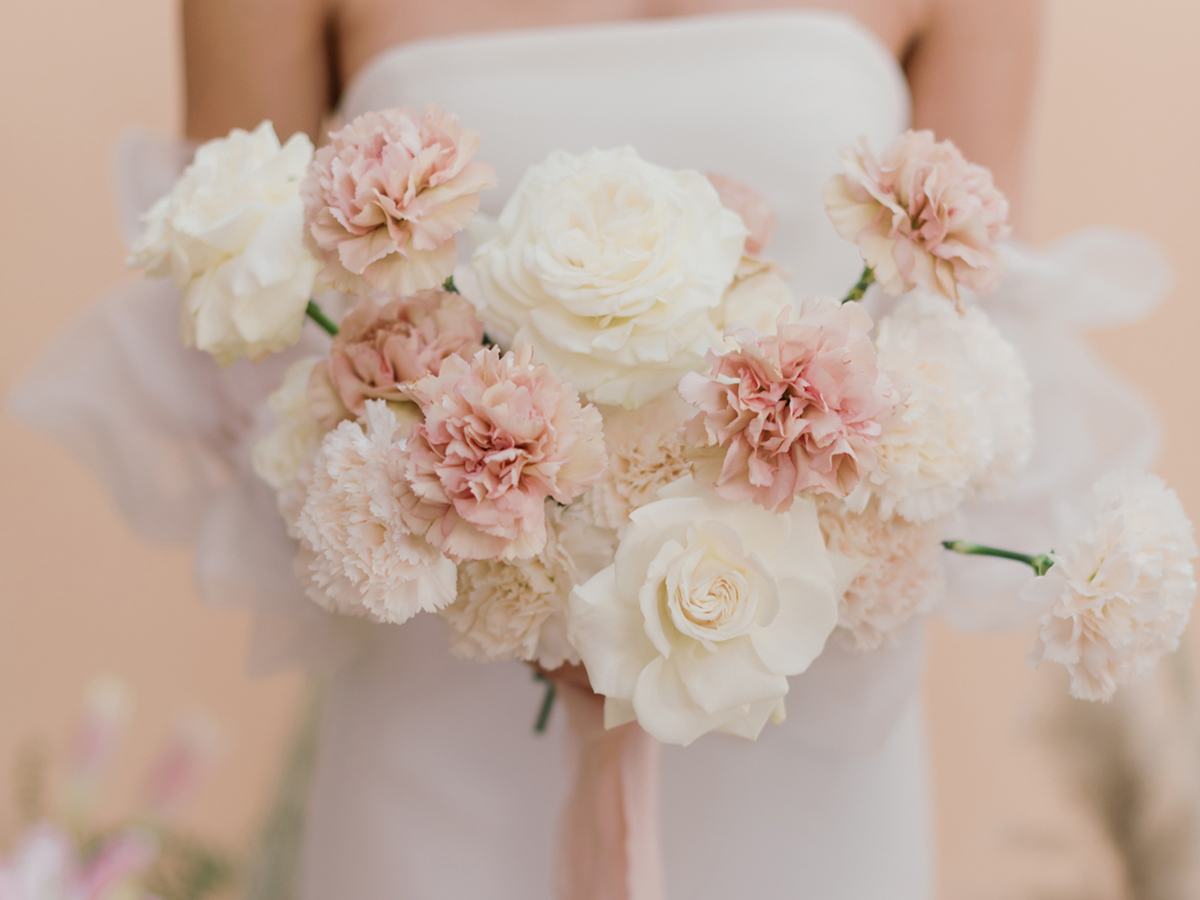 Blush bridal bouquet featuring carnations and white garden roses
