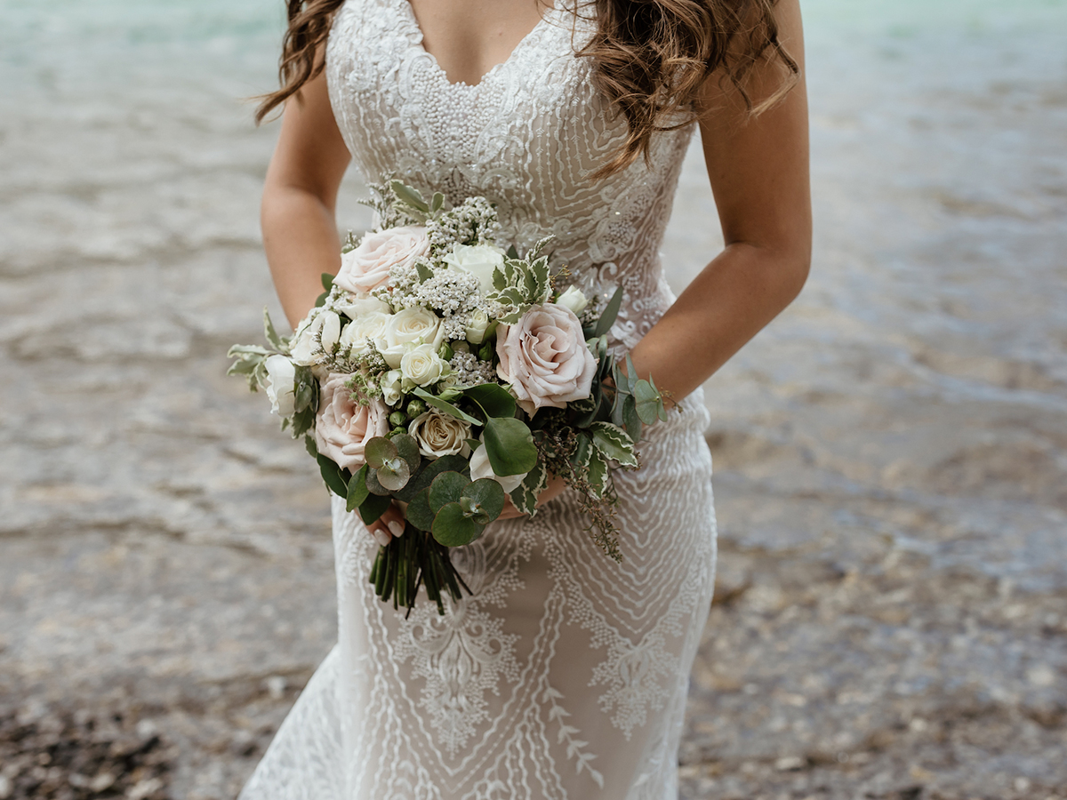 Blush bridal bouquet featuring quicksand roses, ivory spray roses and white yarrow