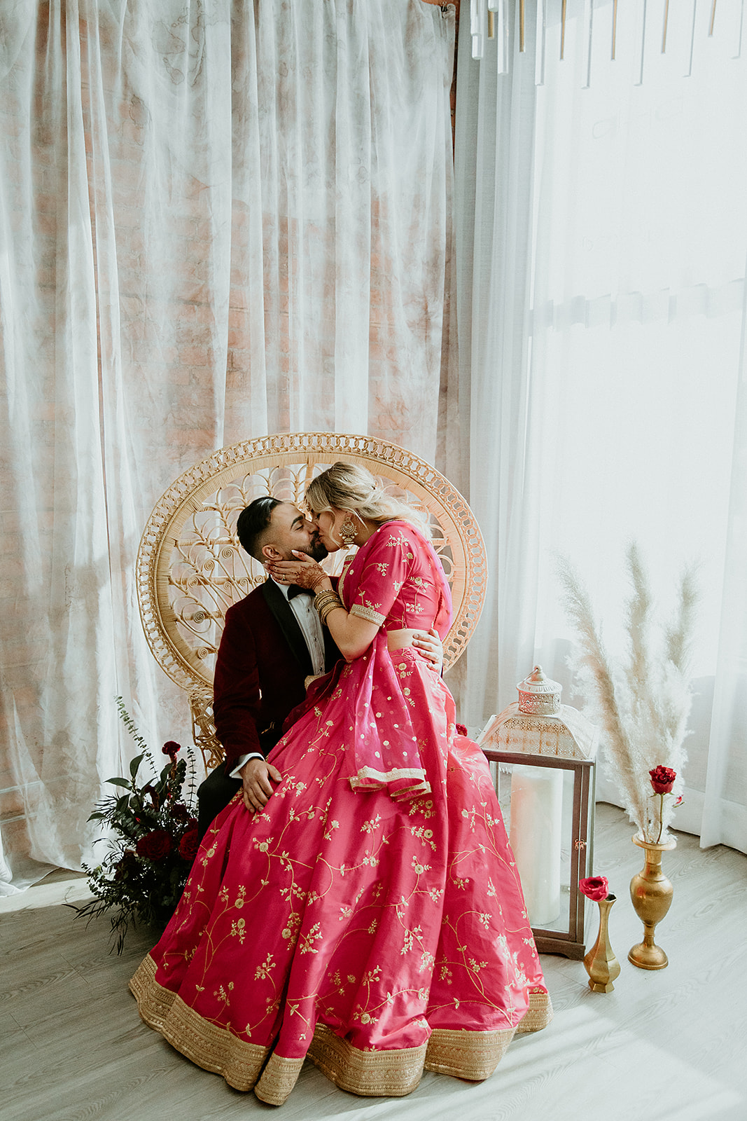 Indian and Moroccan inspired wedding with a bright pink lehenga, wild pampas grass and jewel tones