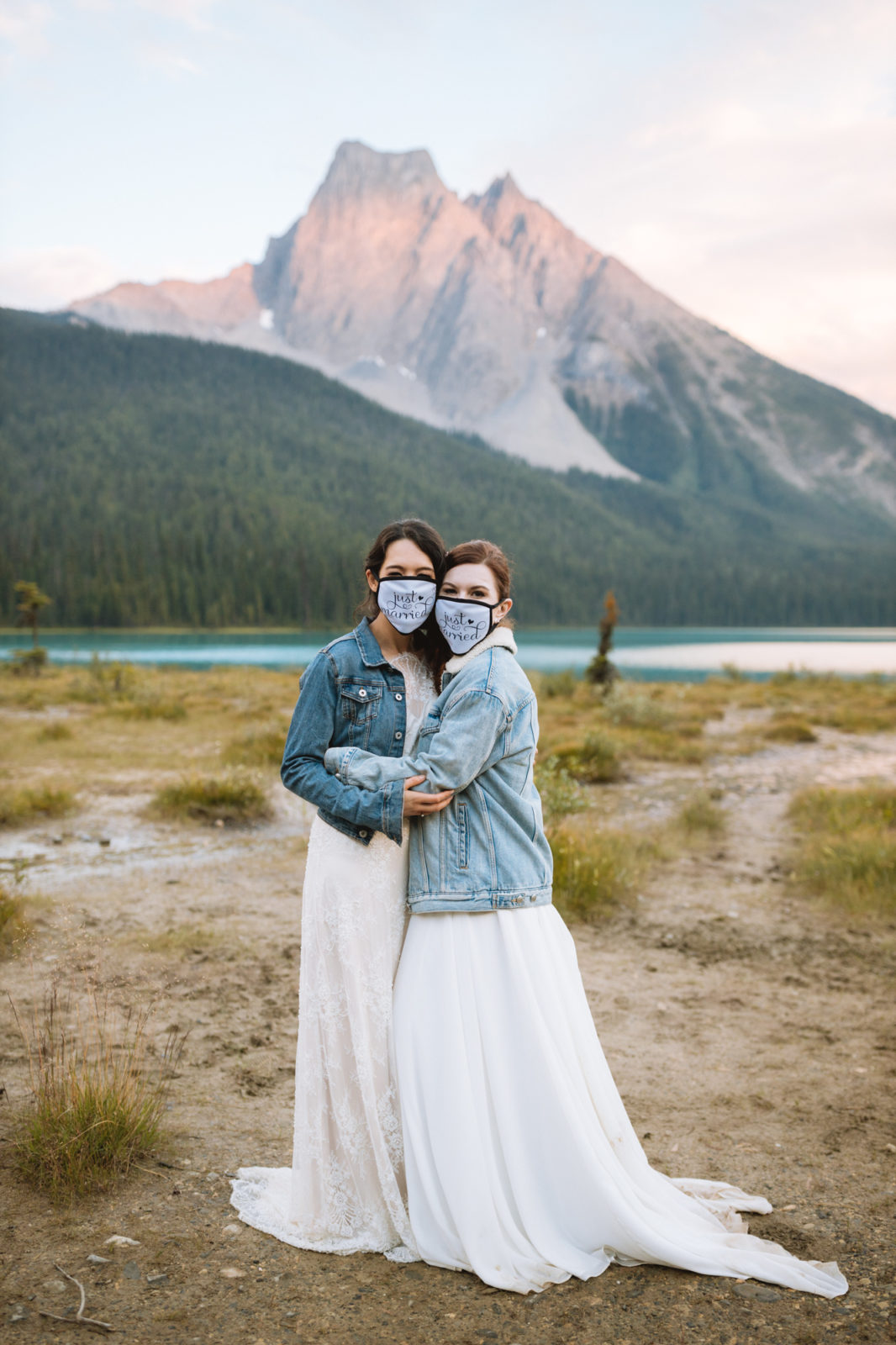 Newly weds pose in their matching jean jackets and Just Married masks for their Elopement in Yoho National Park