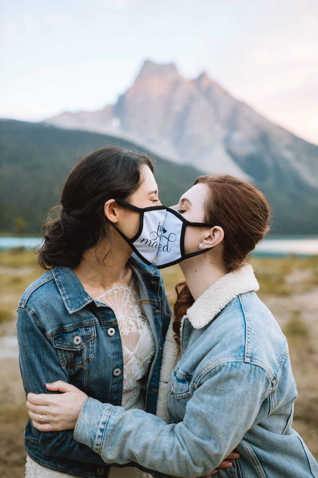 Newly weds share a kiss with their just married masks on 
