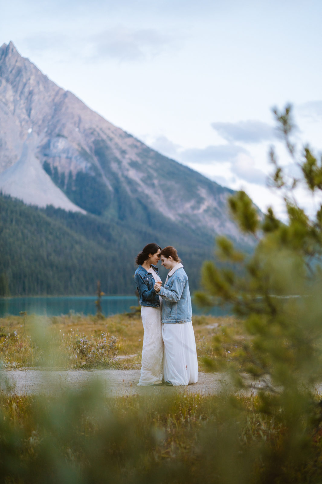 Newly wed couple shares a romantic moment with the mountains of Yoho National Park in the background