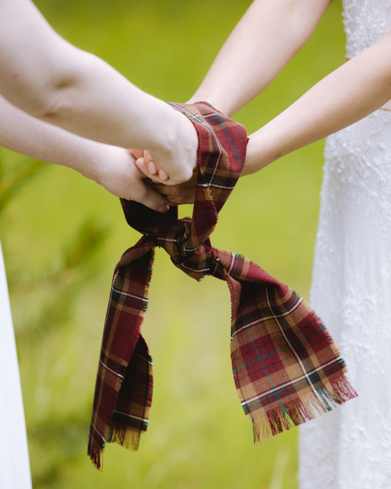 Hand fastening ceremony with a tartan scarf at an Elopement in Yoho National Park