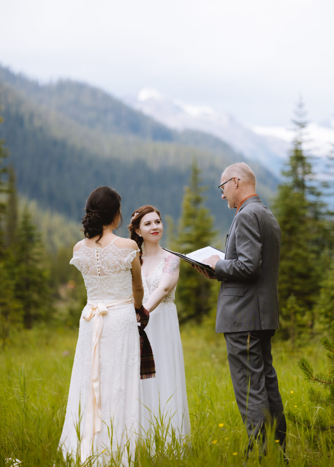 Two brides stand before their commissioner for their Elopement in Yoho National Park