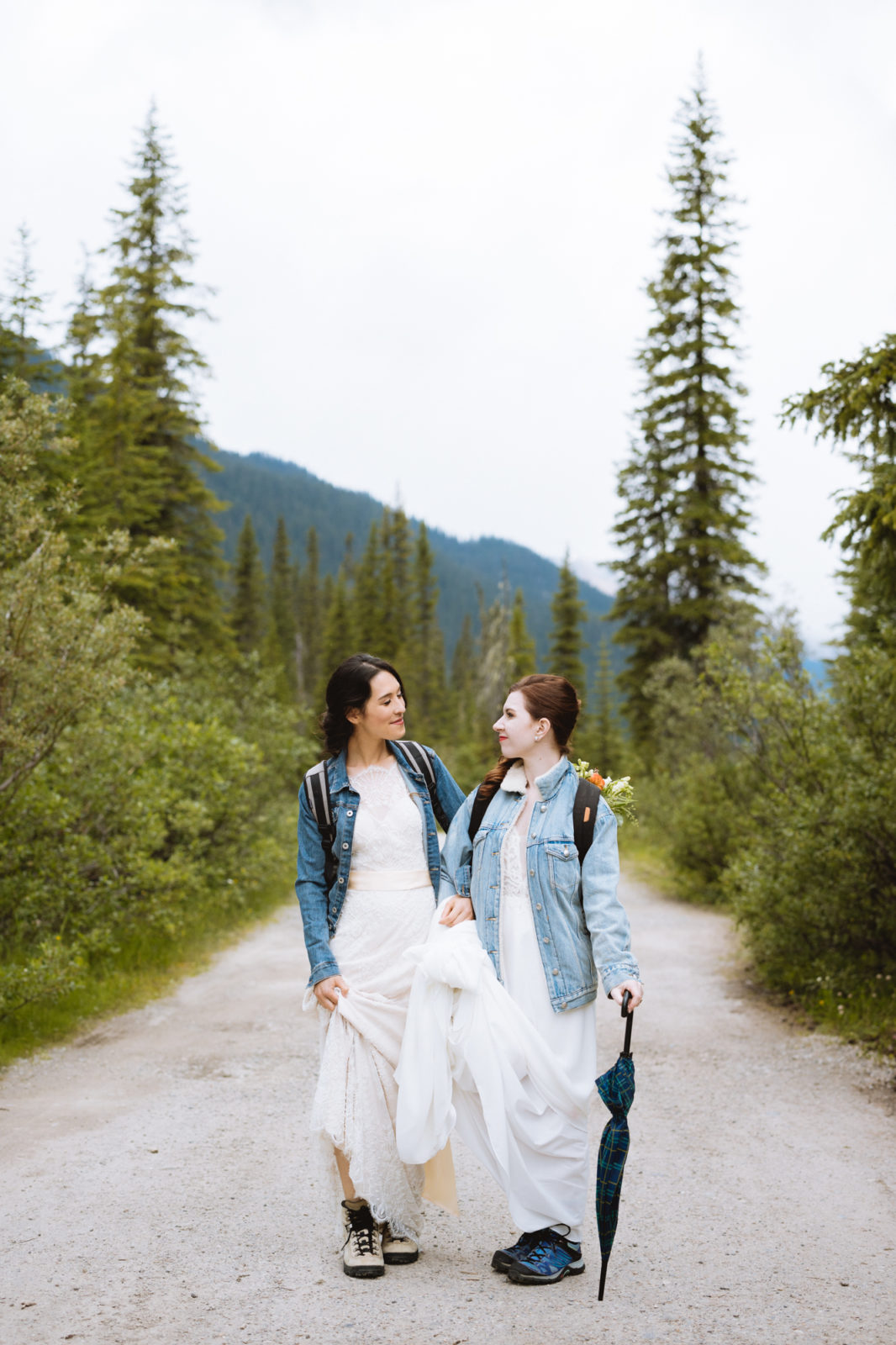 Brides wear matching jean jackets and hiking boots for their Elopement in Yoho National Park