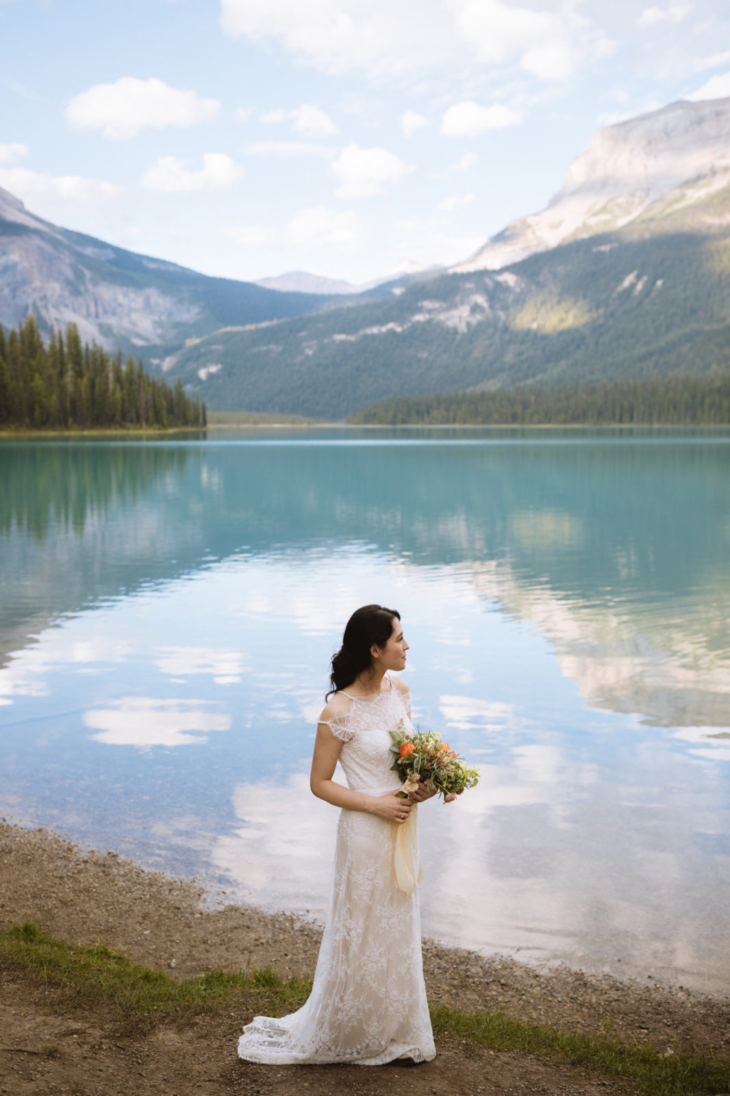 Bride strikes a romantic pose next to Emerald Lake in Yoho National Park