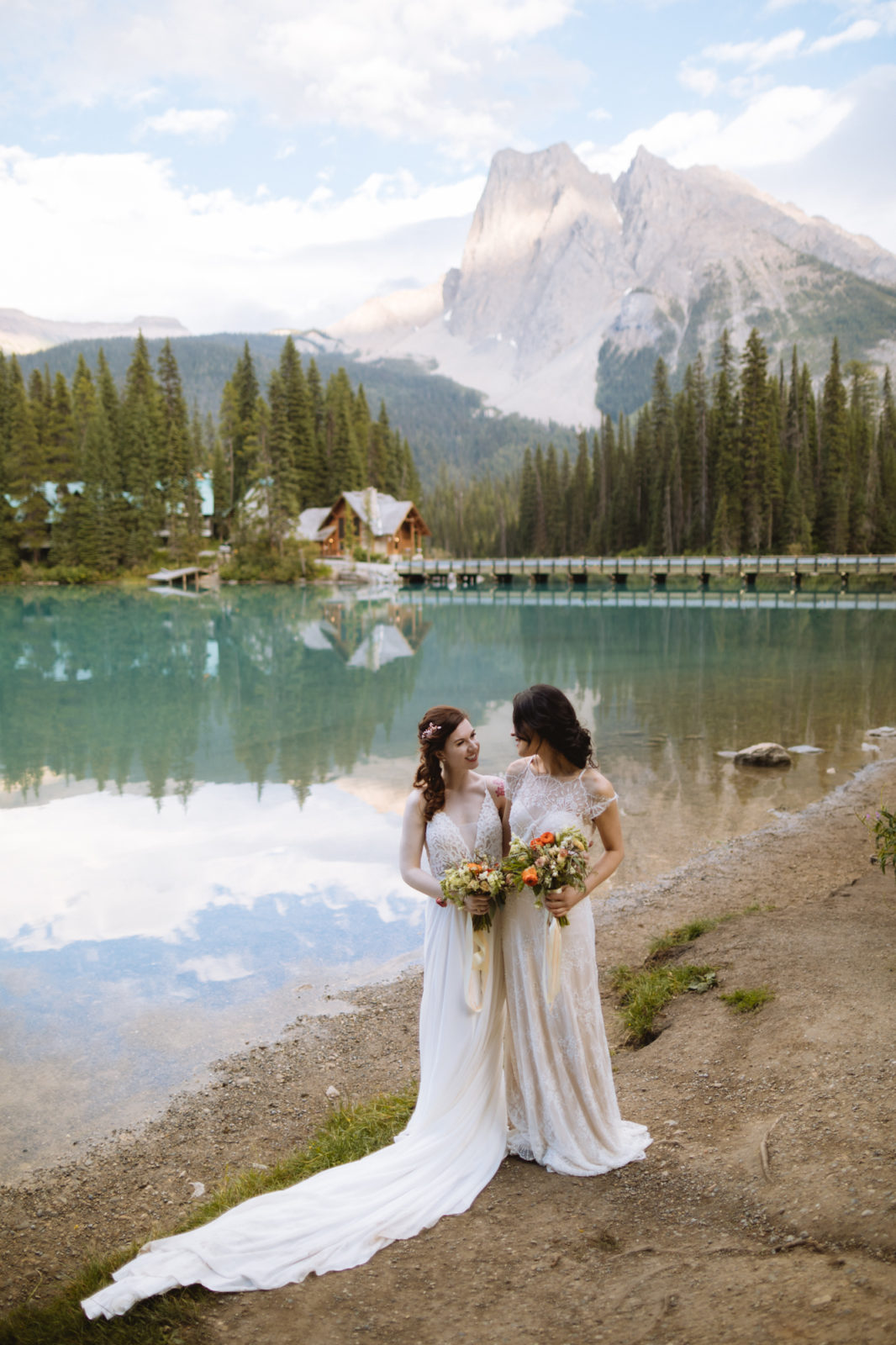 Newly wed couple pose in front of Emerald Lake Lodge for their Elopement in Yoho National Park