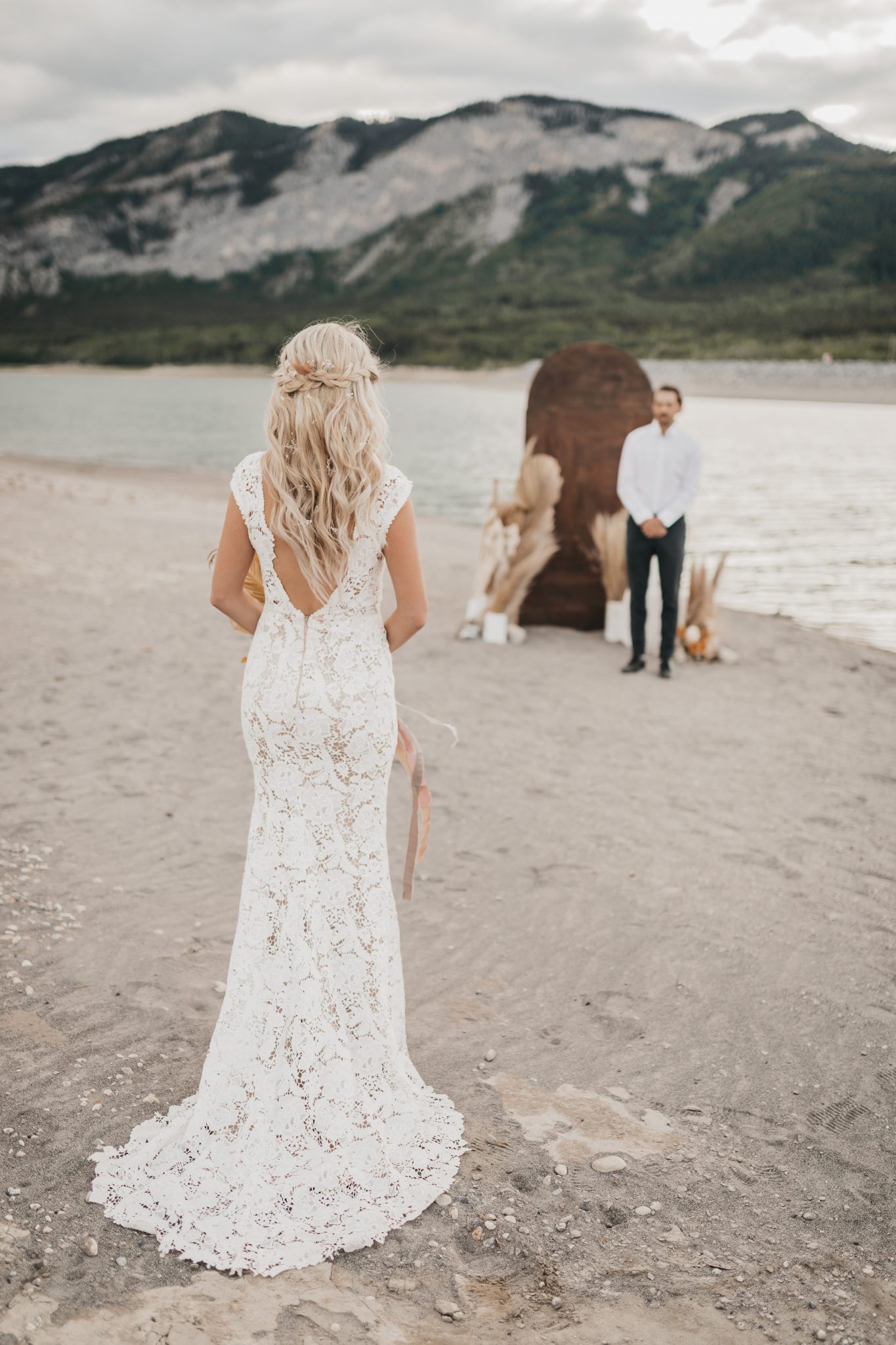 Wooden ceremony arch for boho styled wedding at Barrier Lake