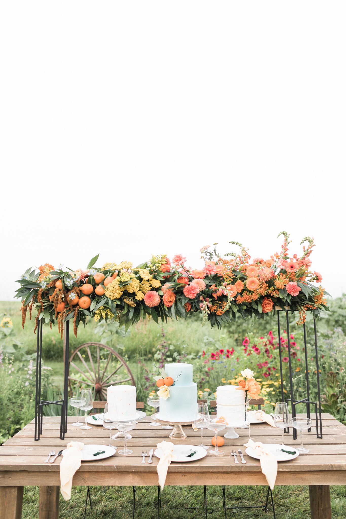 Garden inspired tablescape with a floral arch and robin blue cake