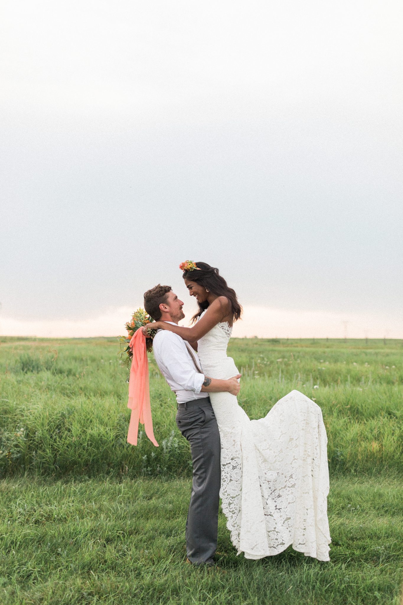 Groom picks up his bride for romantic sunset photos at The Gathered 