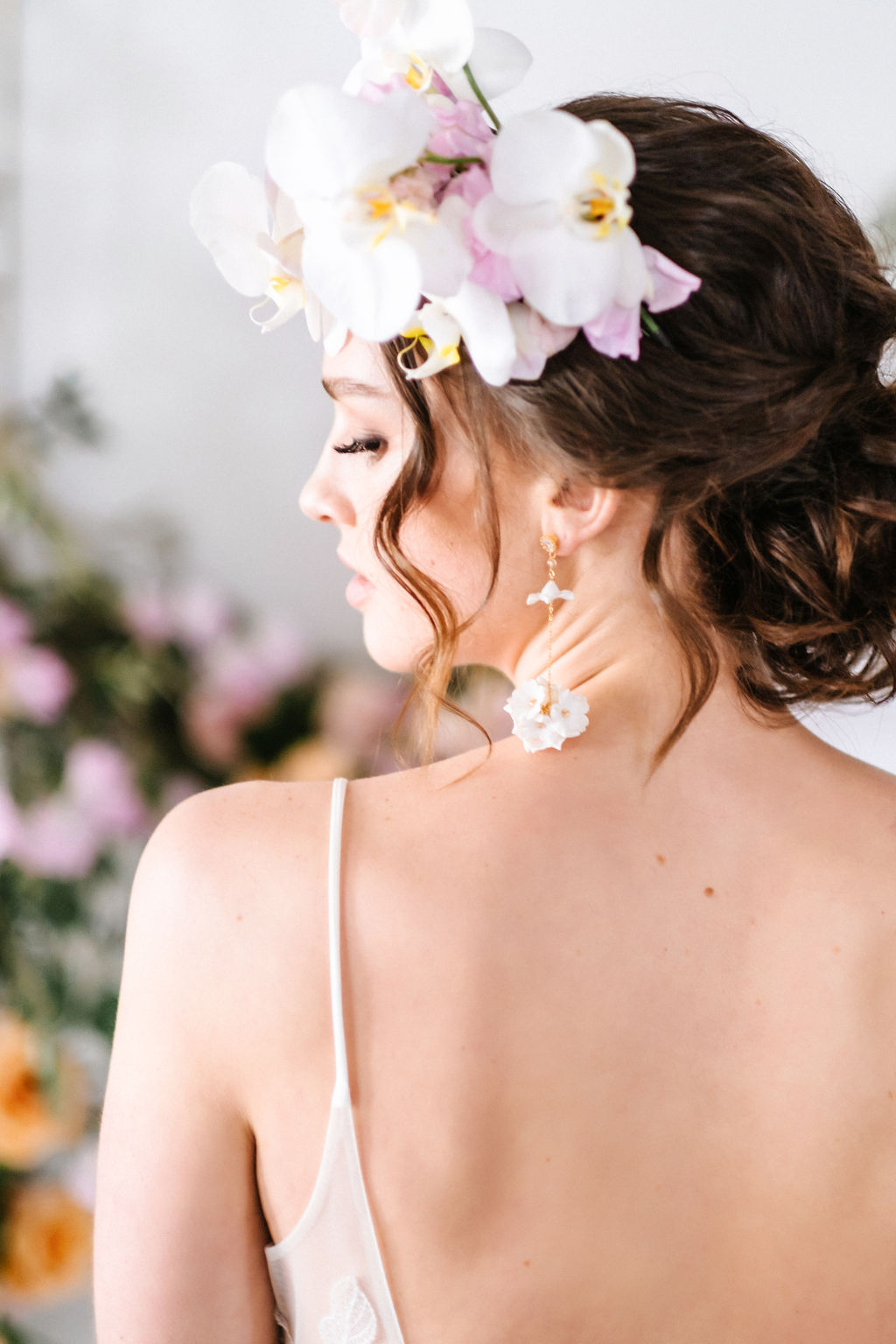 Bride wearing an orchid floral crown and statement Joanna Bisley Design earrings