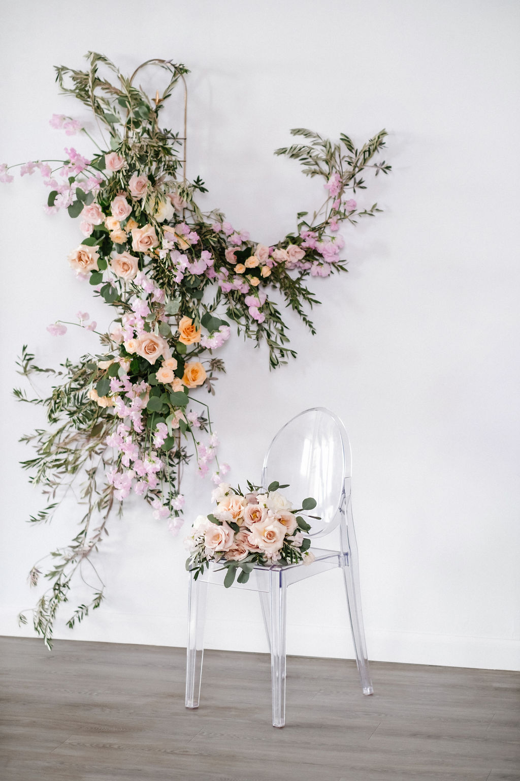 Modern transparent chair at Venue 308 styled with orange and pink flowers