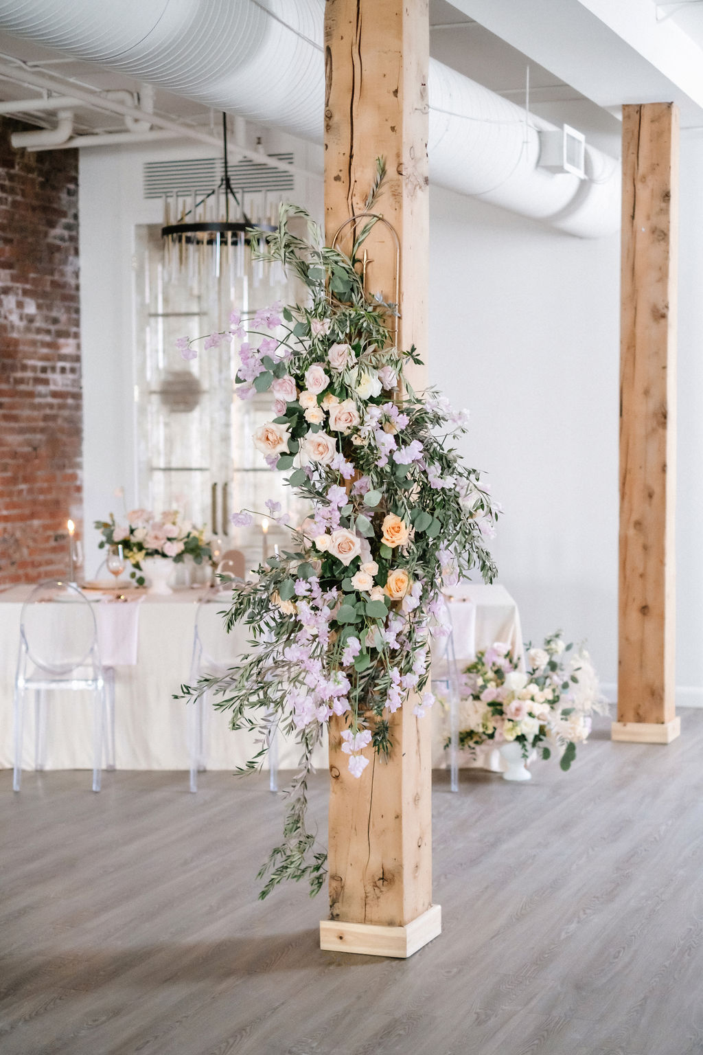 Flower installation at Venue 308 featuring orange, cream, lilac and pink flowers