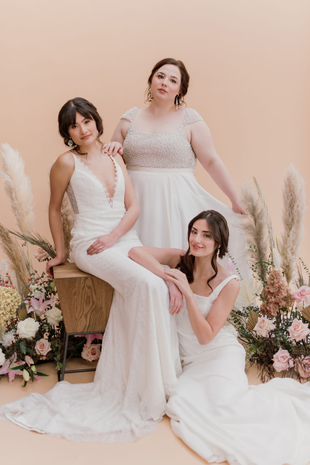 Three models showcase a new collection of wedding gowns a Lovenote Bride in Calgary Alberta