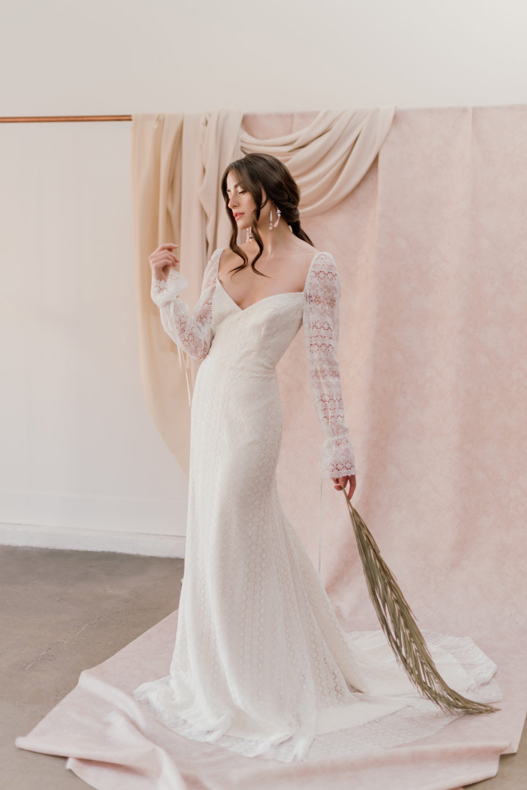 Model poses for a renaissance bridal editorial featuring the Barcelona gown by Laudae