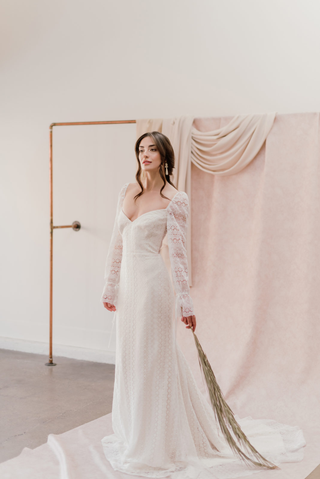 Model poses as a renaissance inspired bride for an editorial at Lovenote Bride in the Barcelona wedding dress by Laudae