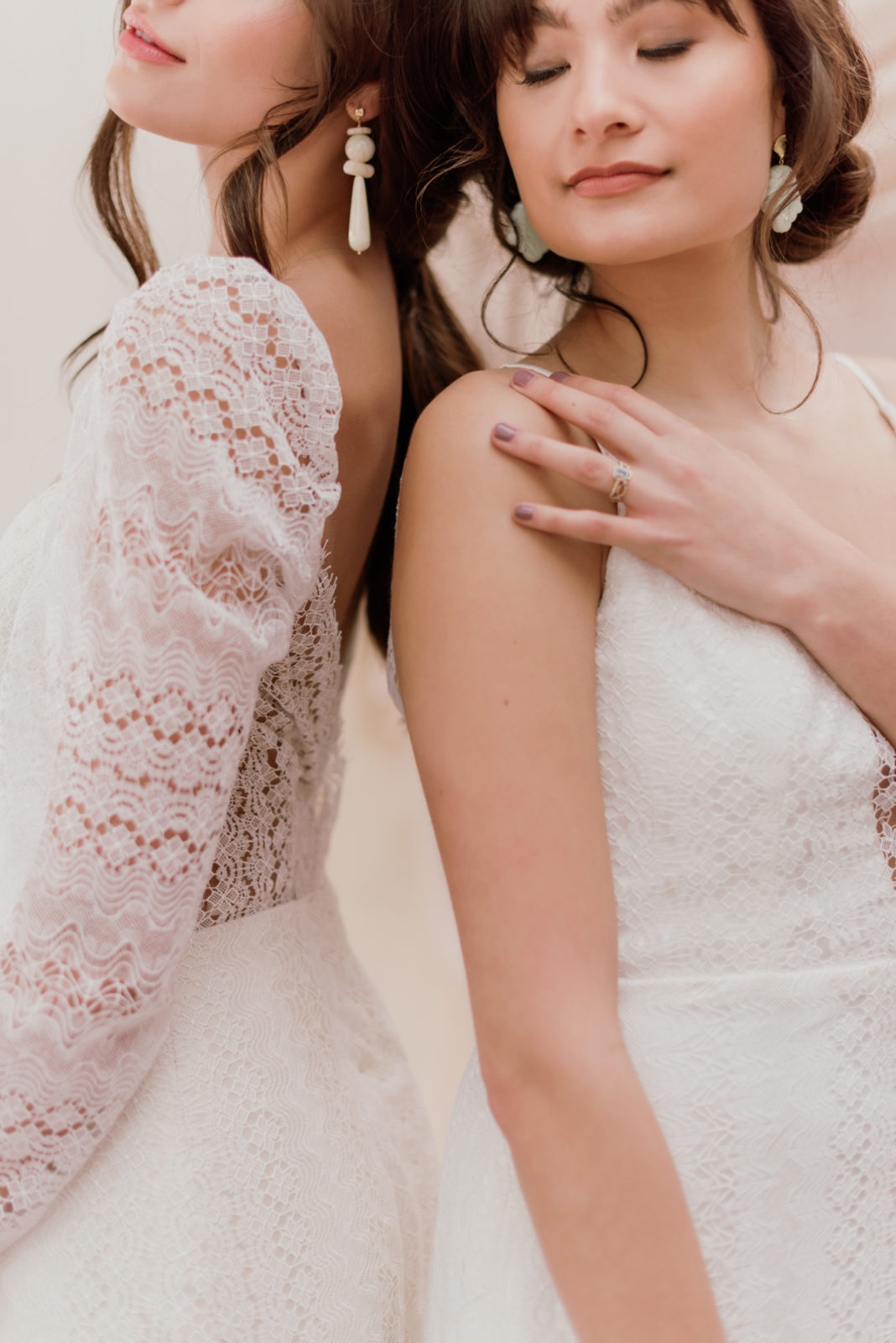 Models pose together showcasing the side view of wedding gowns included in Lovenote Bride's newest collection 