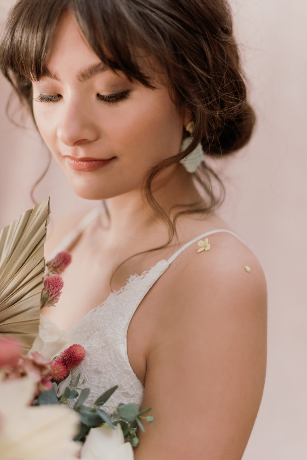 Bridal model poses with a bouquet of dried florals