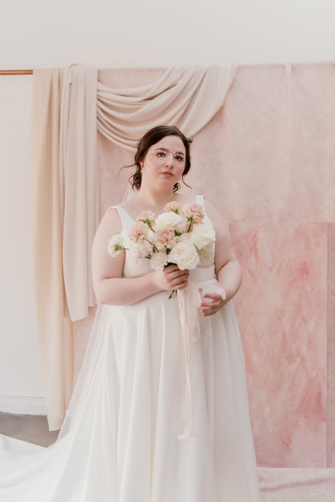 Model poses as a renaissance inspired bride in the Selcouth wedding dress by Aesling for an editorial at Lovenote Bride
