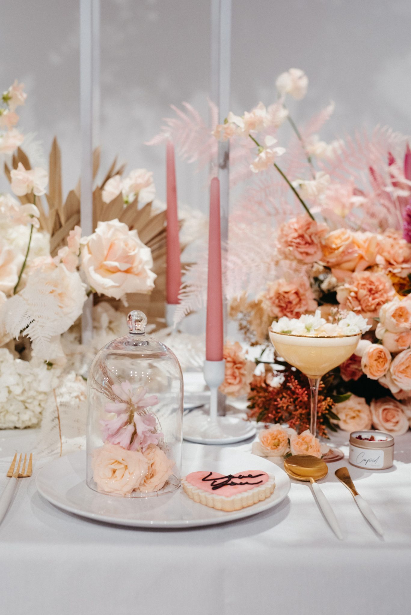 Pink ombre floral tablescape with a heart shaped cookies