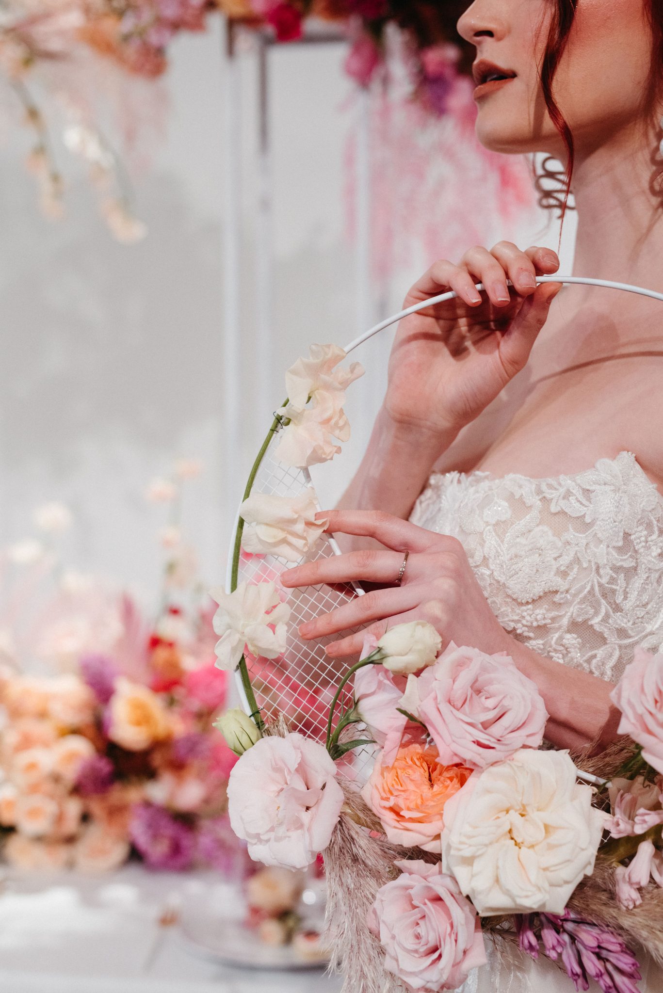 Pink ombre floral hoop held by a bride