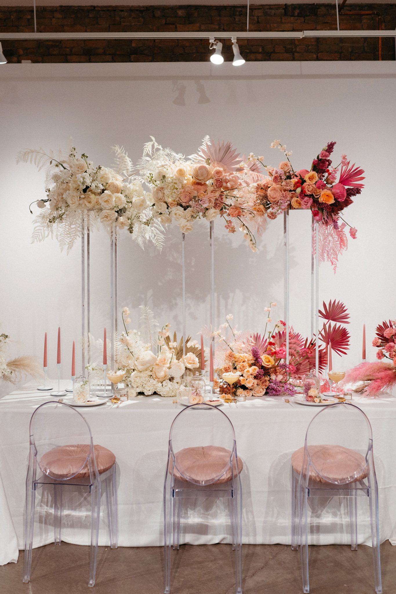 Pink ombre floral installation above a wedding table for wedding decor inspiration