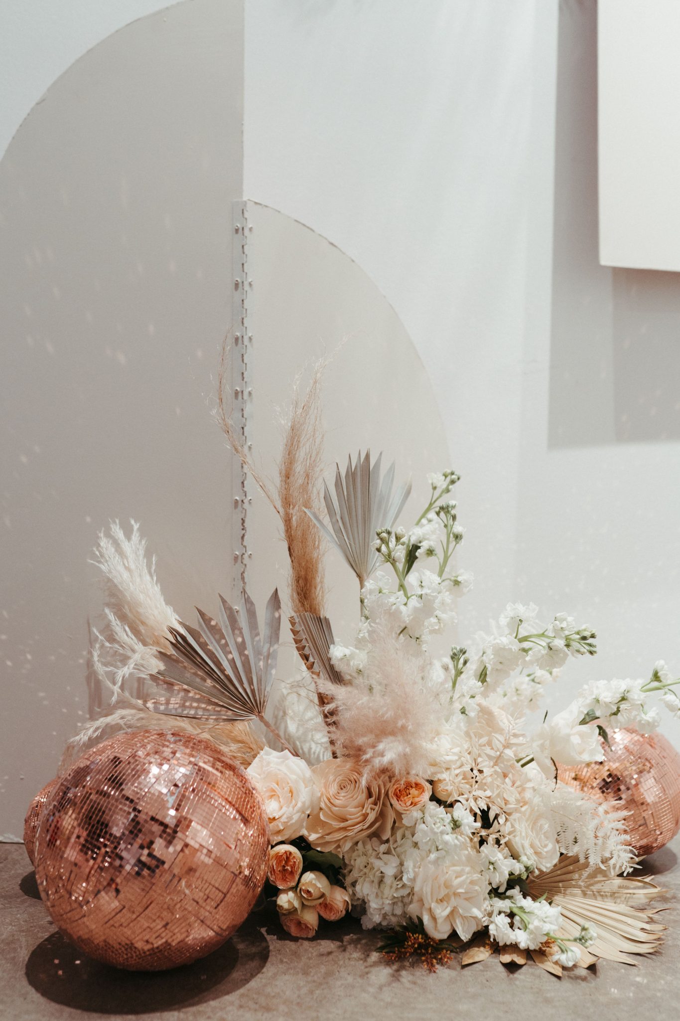 Dried floral wedding decor featuring a rose gold disco ball